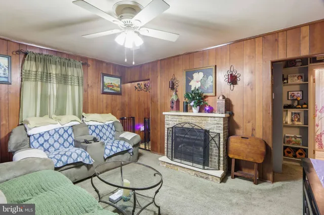 a living room with furniture and a fireplace
