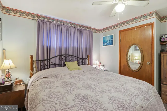 a bed room with a bed mirror and a window