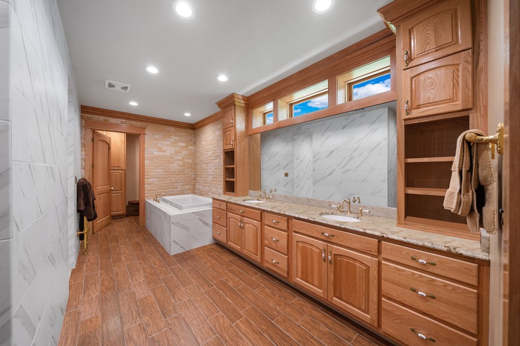 0 County Road 289 Ballinger, TX 76821 - Photo 17 of 61 a spacious bathroom with a granite countertop sink a mirror and a bathtub