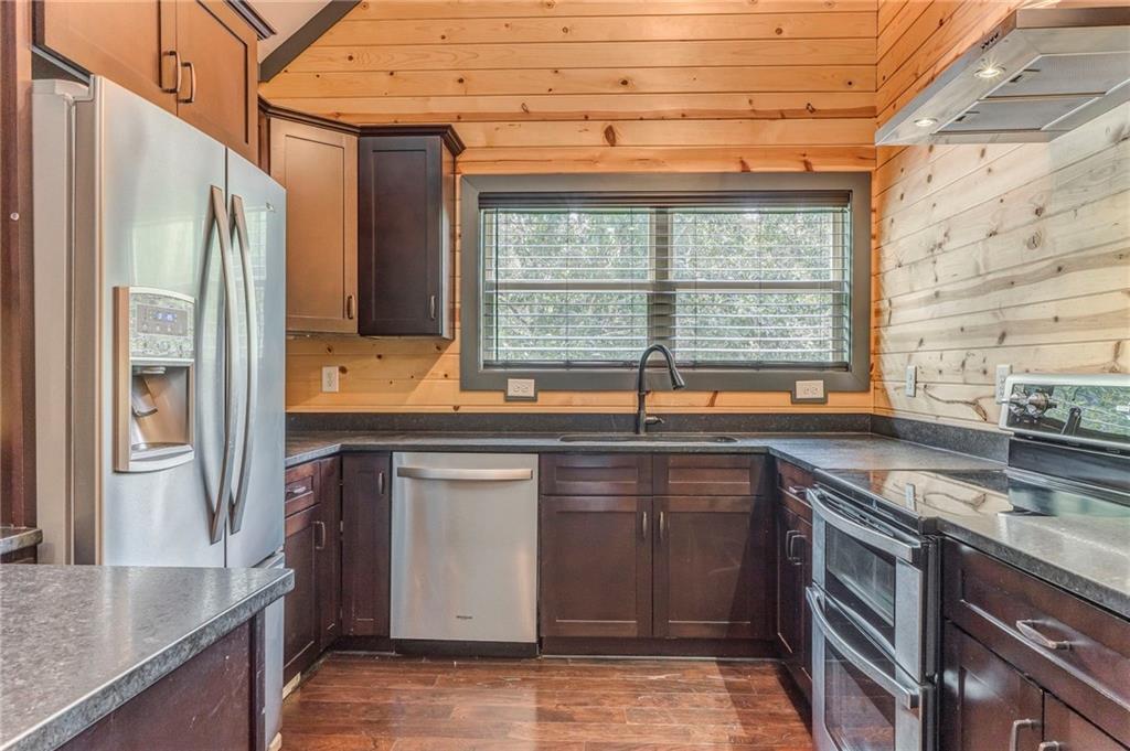 850 Bethel Church Road Southeast Silver Creek, GA 30173 - Photo 12 of 52 a kitchen with stainless steel appliances granite countertop a sink and a refrigerator