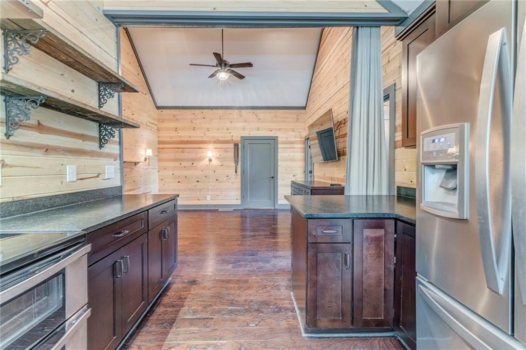 850 Bethel Church Road Southeast Silver Creek, GA 30173 - Photo 14 of 52 a kitchen with stainless steel appliances granite countertop a sink and wooden cabinets