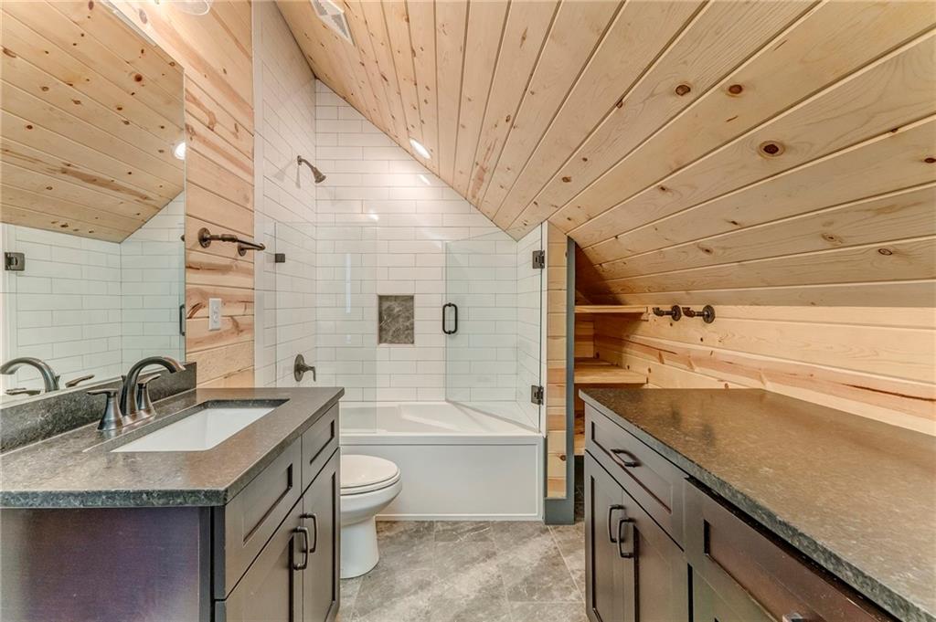 850 Bethel Church Road Southeast Silver Creek, GA 30173 - Photo 24 of 52 a bathroom with a granite countertop sink a toilet and bathtub