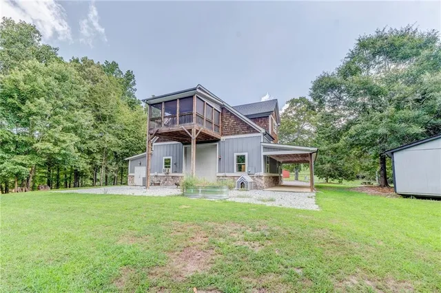 a front view of house with yard and green space