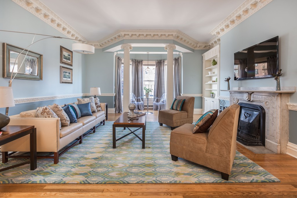 a living room with furniture a fireplace and a flat screen tv
