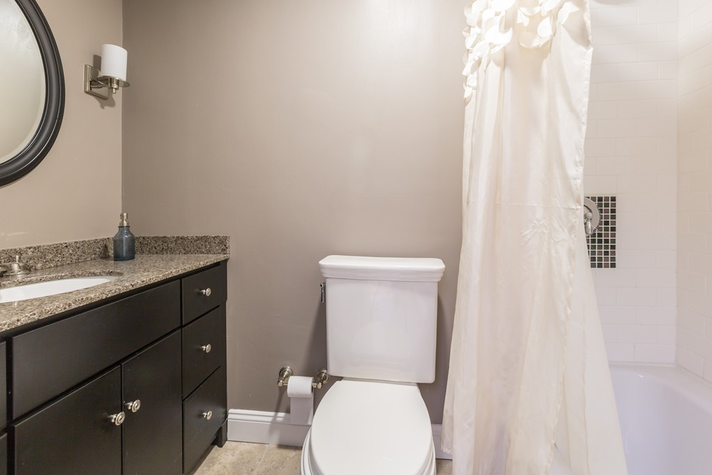 193 Beacon Street, Unit 4 Boston, MA 02116 - Photo 11 of 22 a bathroom with a toilet sink and mirror