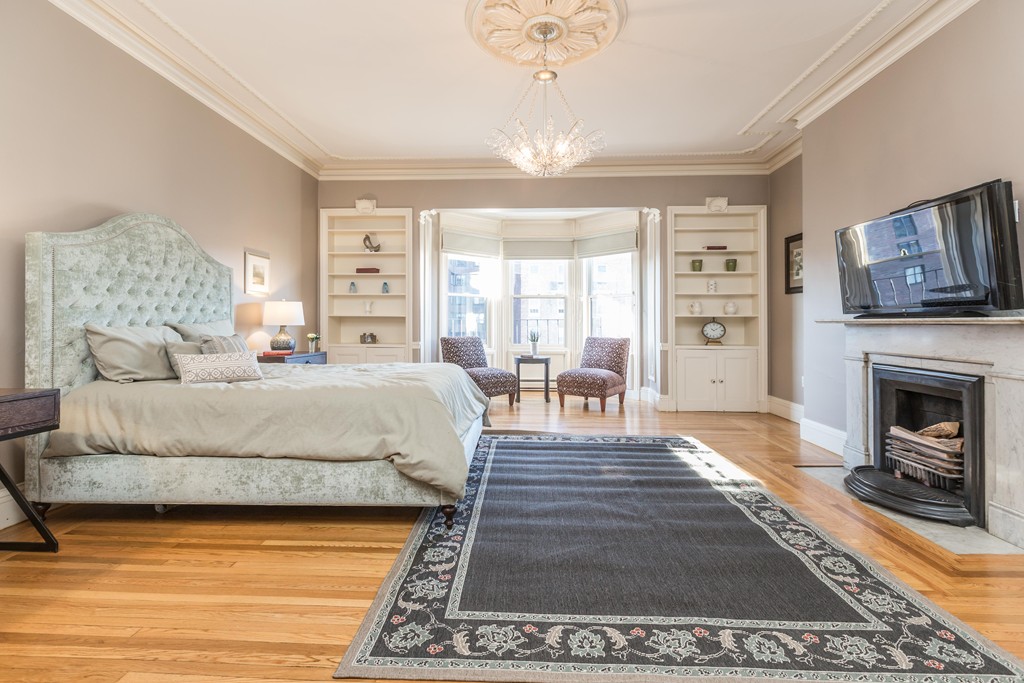 193 Beacon Street, Unit 4 Boston, MA 02116 - Photo 16 of 22 a spacious bedroom with a balcony a bed and a fireplace