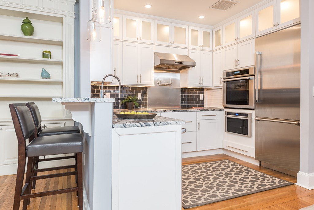 193 Beacon Street, Unit 4 Boston, MA 02116 - Photo 8 of 22 a kitchen with a refrigerator and furniture