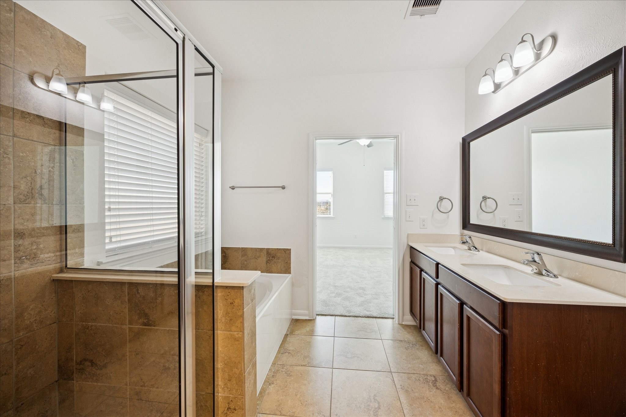 8115 Aleppo Pine Lane Cypress, TX 77433 - Photo 20 of 32 a bathroom with a double vanity sink a mirror and a shower