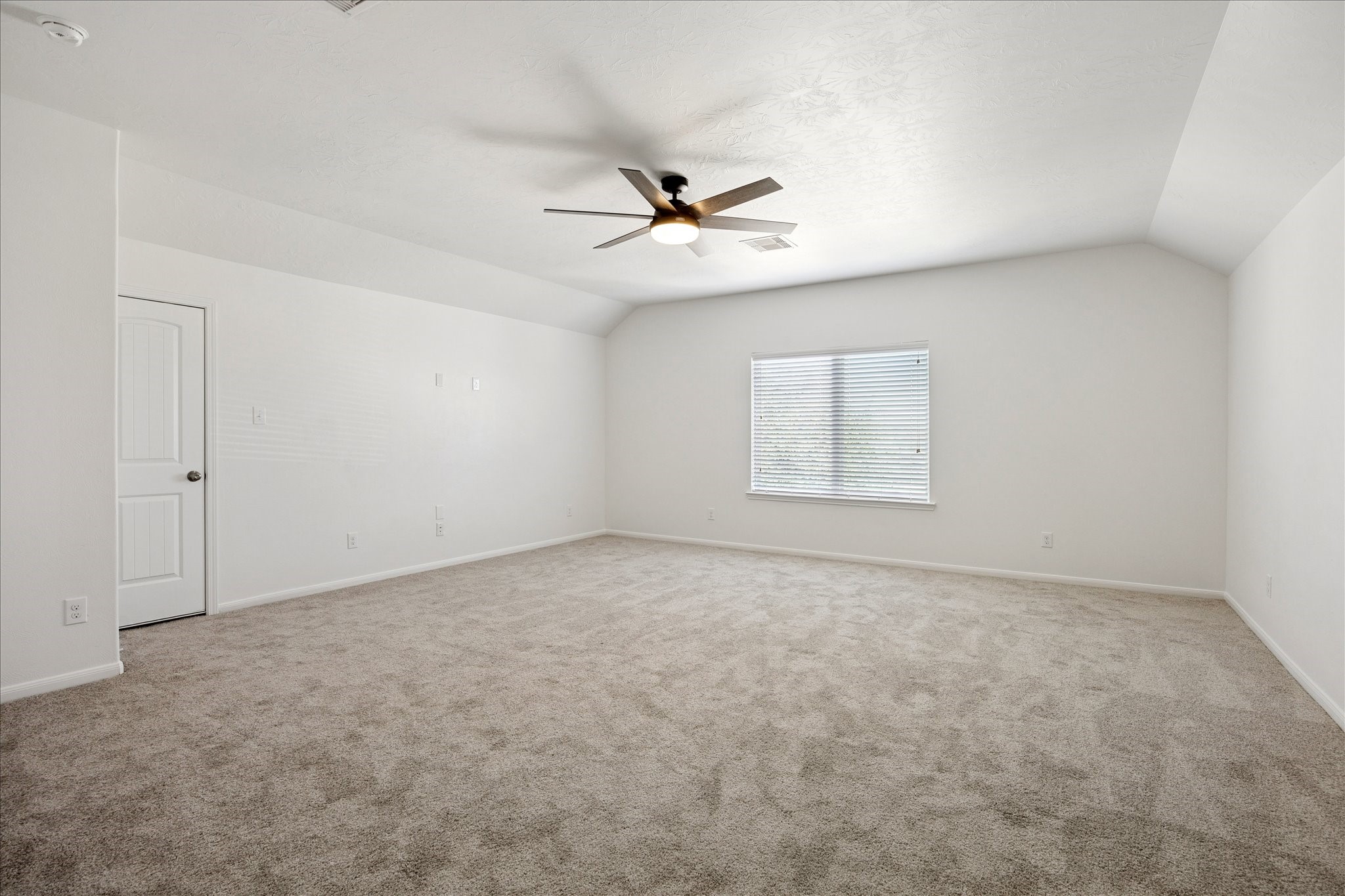 8115 Aleppo Pine Lane Cypress, TX 77433 - Photo 22 of 32 en empty room with windows and ceiling fan view