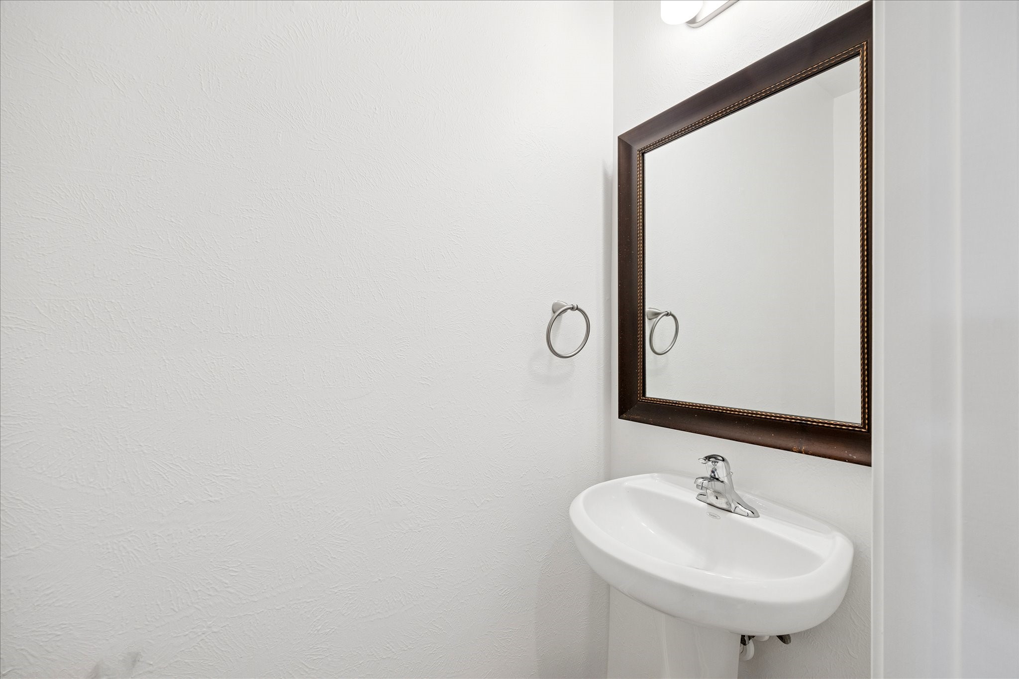 8115 Aleppo Pine Lane Cypress, TX 77433 - Photo 29 of 32 a bathroom with a sink and a mirror