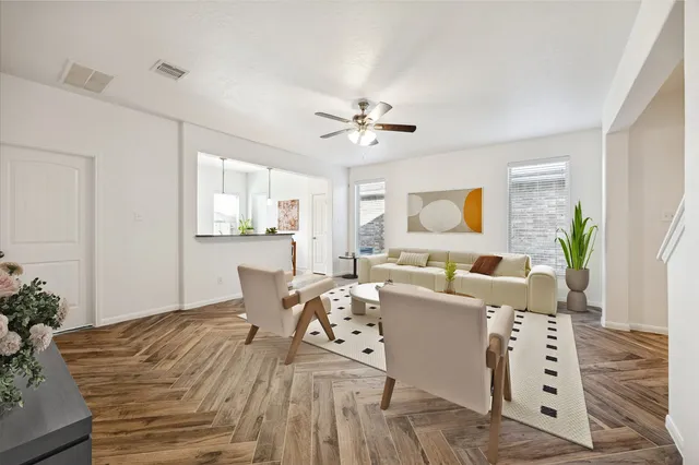 a view of a bedroom with a ceiling fan