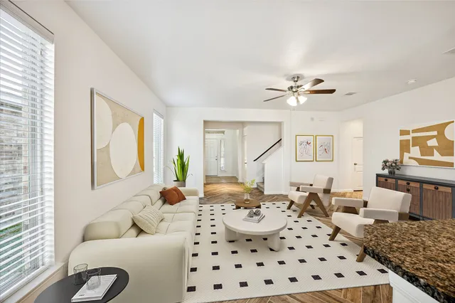 a kitchen with stainless steel appliances a dining table chairs and granite counter tops