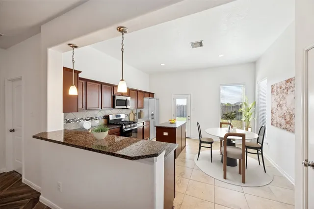 a kitchen with stainless steel appliances granite countertop a sink and cabinets