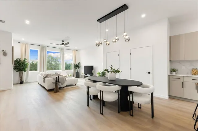 a large kitchen with a table and chairs