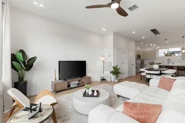 a living room with furniture and a potted plant