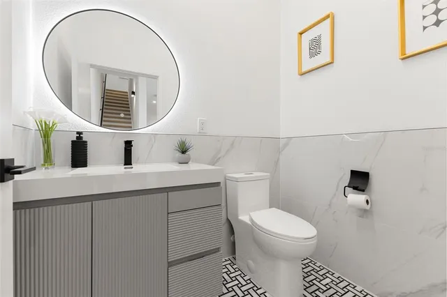 a bedroom with furniture and a large window