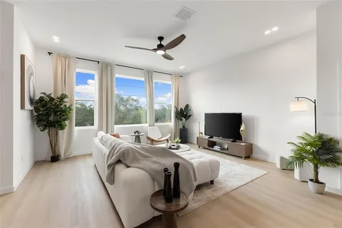 a bedroom with a bed and a large window