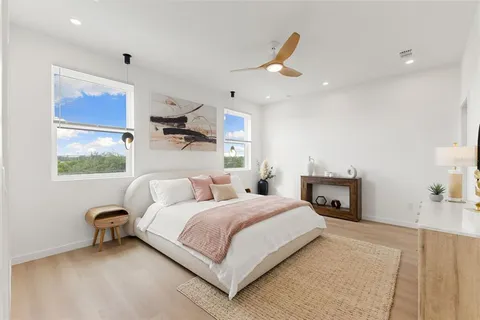 a bedroom with a bed couch and window