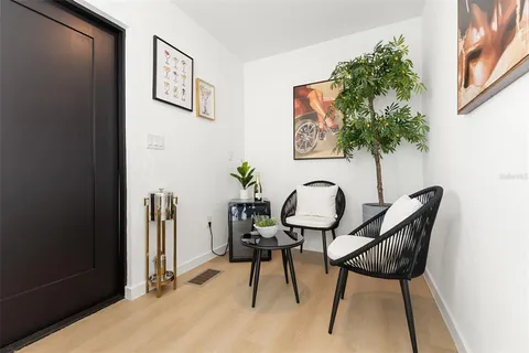 a balcony with chairs and a table