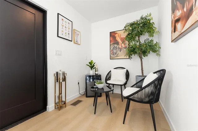 a balcony with chairs and a table