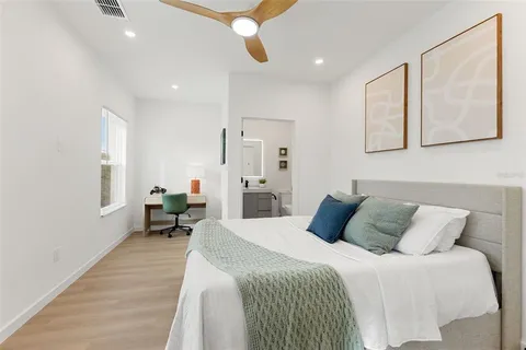 a bedroom with a bed mirror and a window