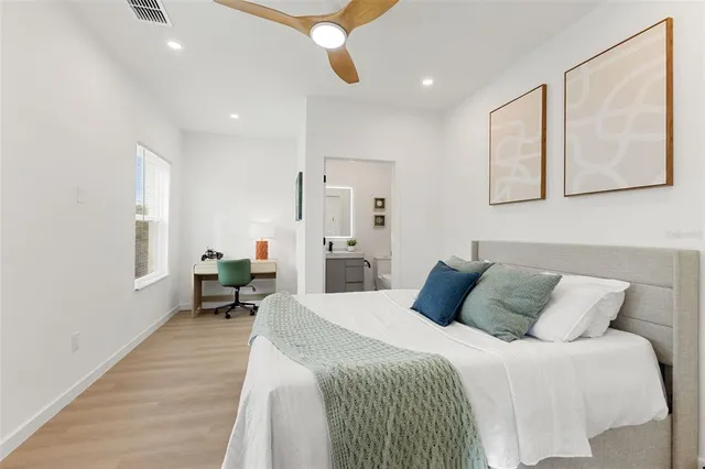 a bedroom with a bed mirror and a window