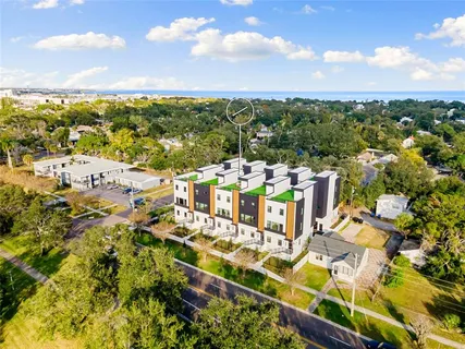 an aerial view of residential houses with outdoor space and swimming pool