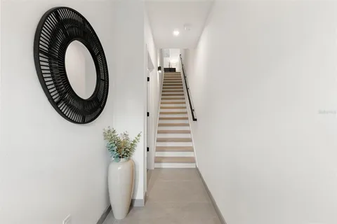 a view of entryway with washer and white wooden floor