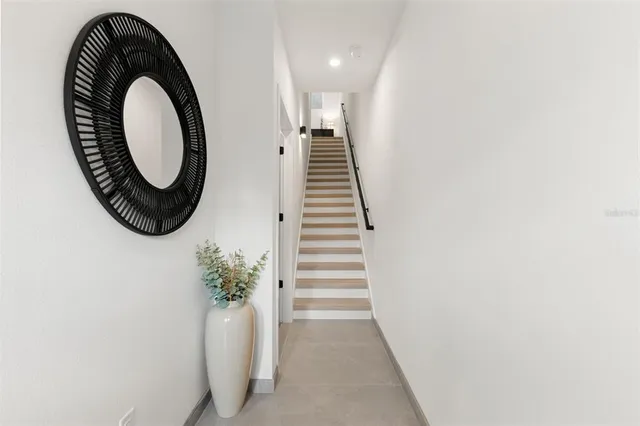a view of entryway with washer and white wooden floor