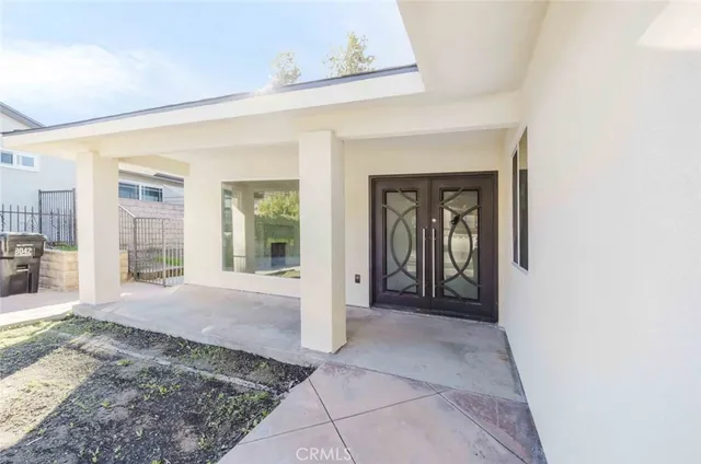 a view of a hallway with wooden floor and a living room