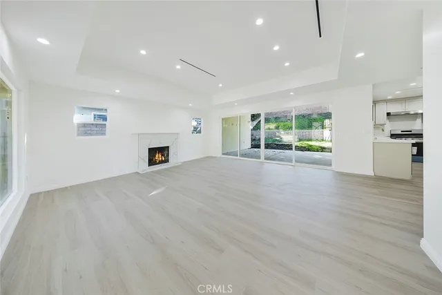 an empty room with furniture and a fireplace