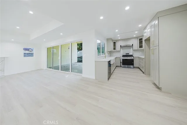 a view of a kitchen with a sink and cabinets