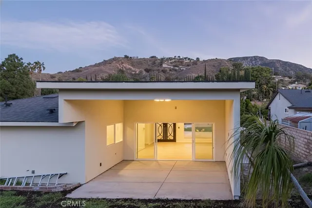 a view of swimming pool with a yard and mountain view