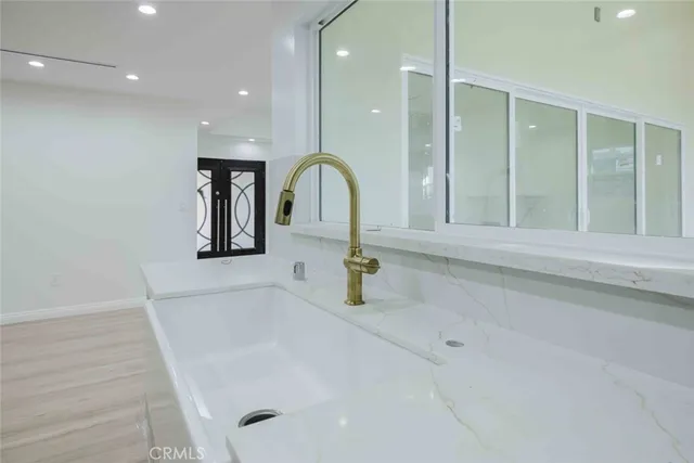 a bathroom with a tub sink and mirror