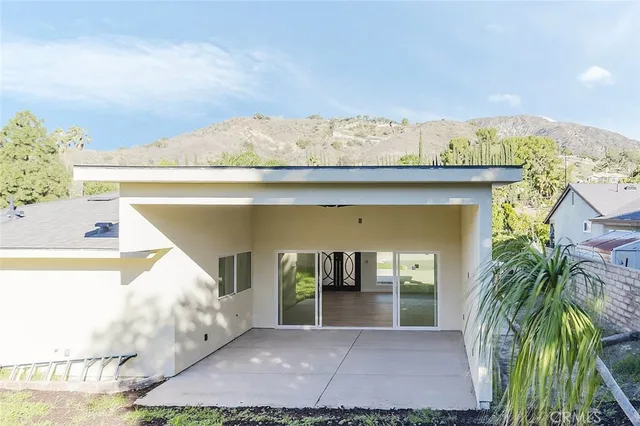 en empty room with sliding door and wooden floor