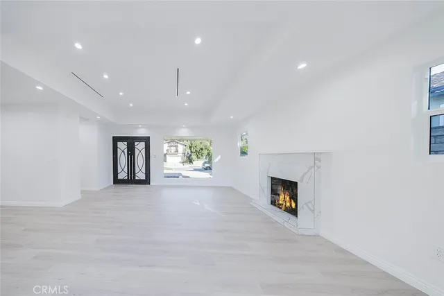 a view of an empty room with a fireplace