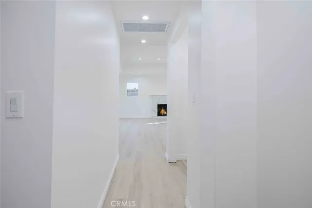 an empty room with a window and ceiling fan