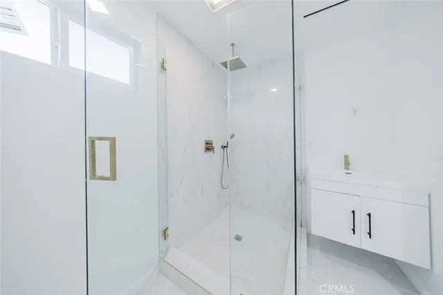a view of a room with a ceiling fan and hardwood floor