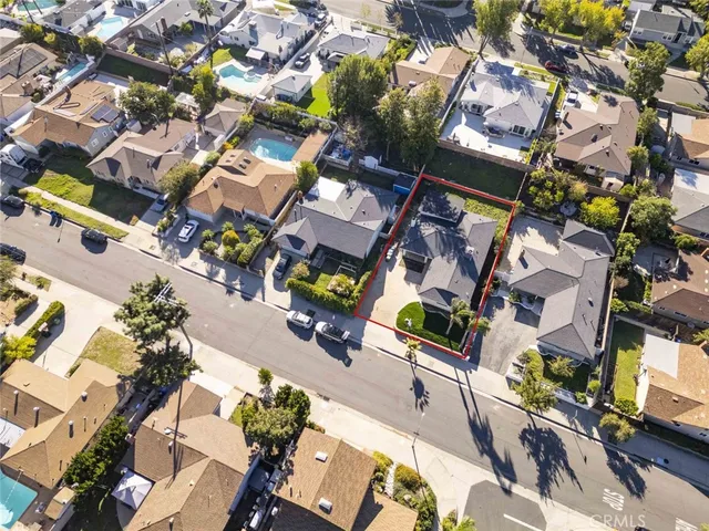 an aerial view of a residential apartment building with yard and parking