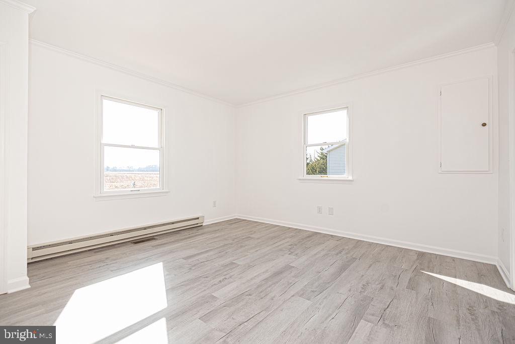 36130 Richland Road Willards, MD 21874 - Photo 17 of 42 an empty room with wooden floor and windows
