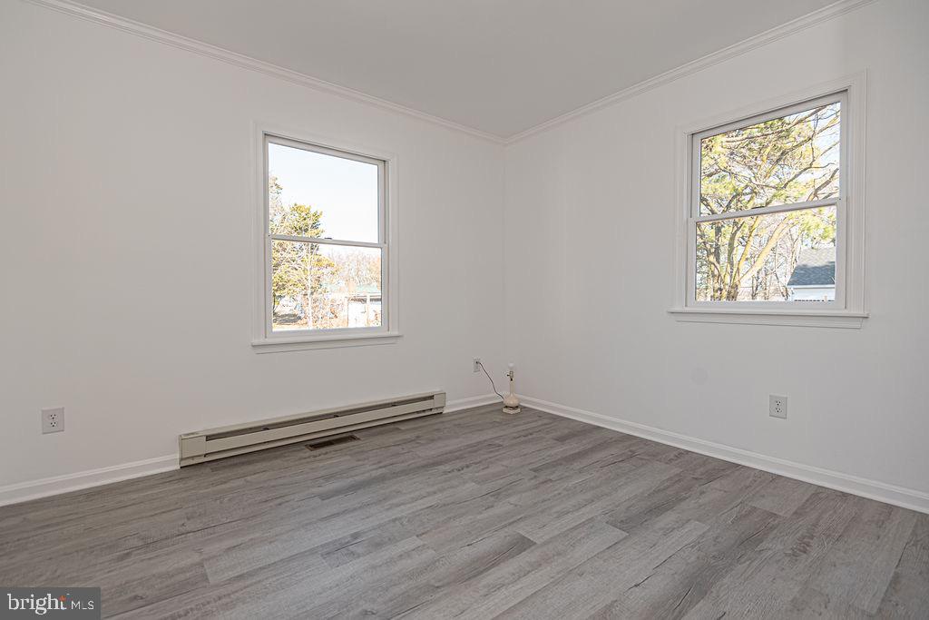 36130 Richland Road Willards, MD 21874 - Photo 25 of 42 an empty room with wooden floor and windows