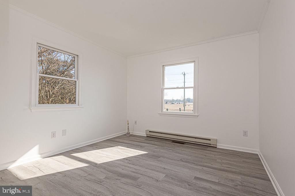 36130 Richland Road Willards, MD 21874 - Photo 27 of 42 an empty room with wooden floor and windows