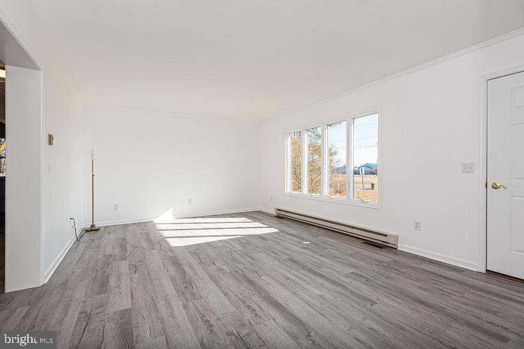 36130 Richland Road Willards, MD 21874 - Photo 5 of 42 an empty room with wooden floor and windows