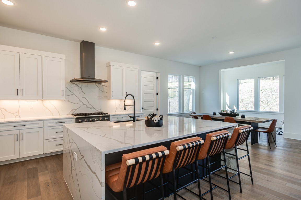 6100 Lookaway Circle Franklin, TN 37067 - Photo 50 of 92 a kitchen with stainless steel appliances granite countertop a stove a sink a table and chairs