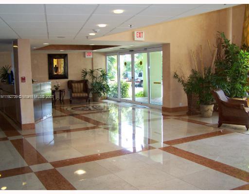 a lobby with furniture and floor to ceiling window