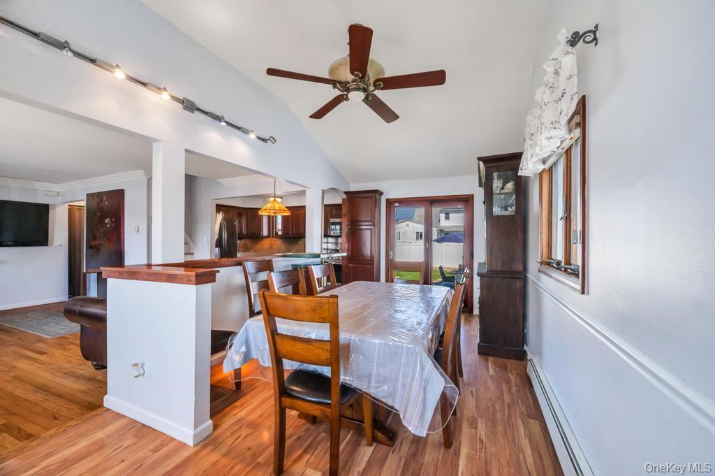 398 33rd Street Lindenhurst, NY 11757 - Photo 16 of 44 a view of a dining room with furniture window and wooden floor