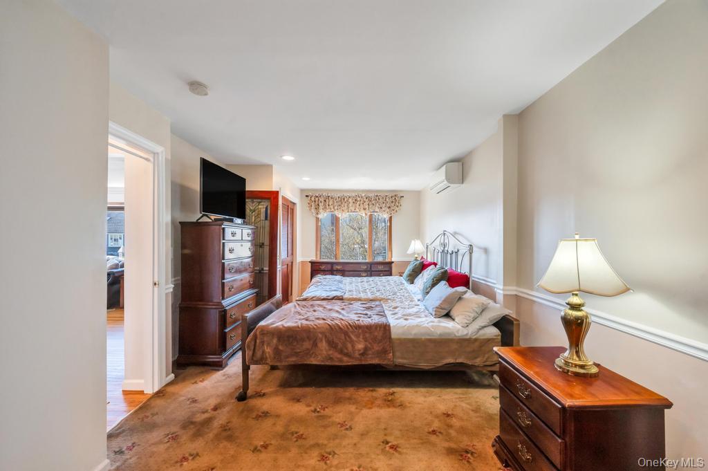 398 33rd Street Lindenhurst, NY 11757 - Photo 23 of 44 a bedroom with a bed and wooden floor