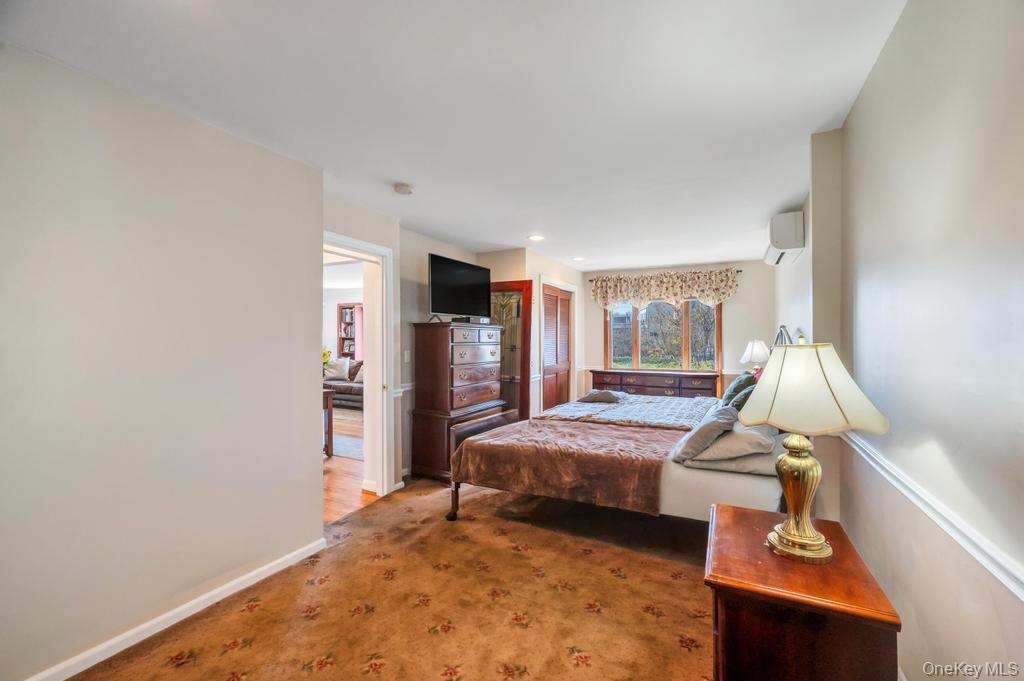 398 33rd Street Lindenhurst, NY 11757 - Photo 24 of 44 a bedroom with bed and glass door