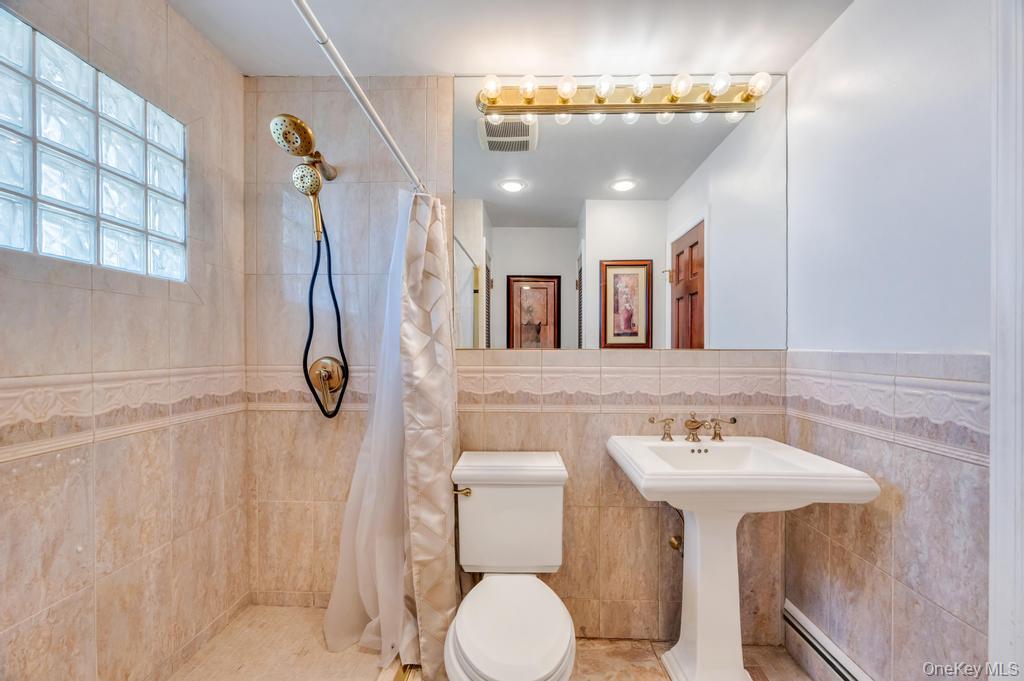 398 33rd Street Lindenhurst, NY 11757 - Photo 27 of 44 a bathroom with a sink mirror and toilet