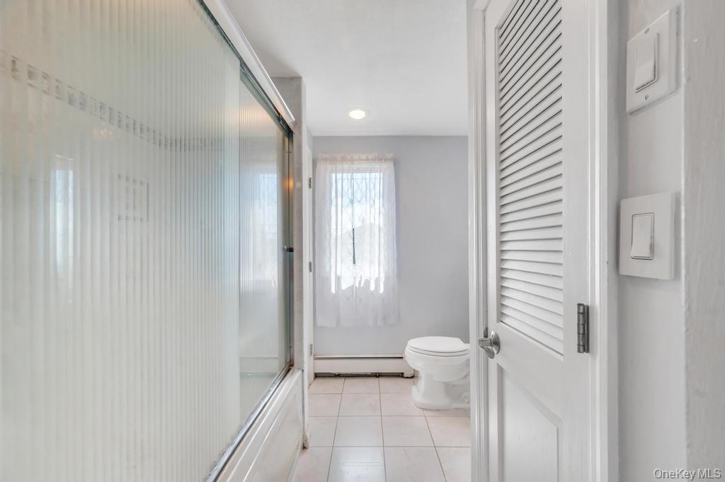 398 33rd Street Lindenhurst, NY 11757 - Photo 30 of 44 a bathroom with a shower and a toilet